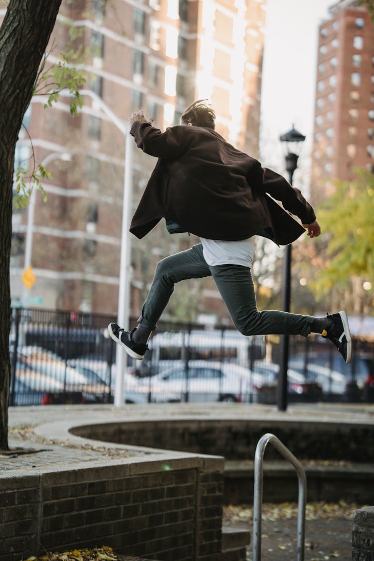 Unrecognizable Man Doing Jump On Street