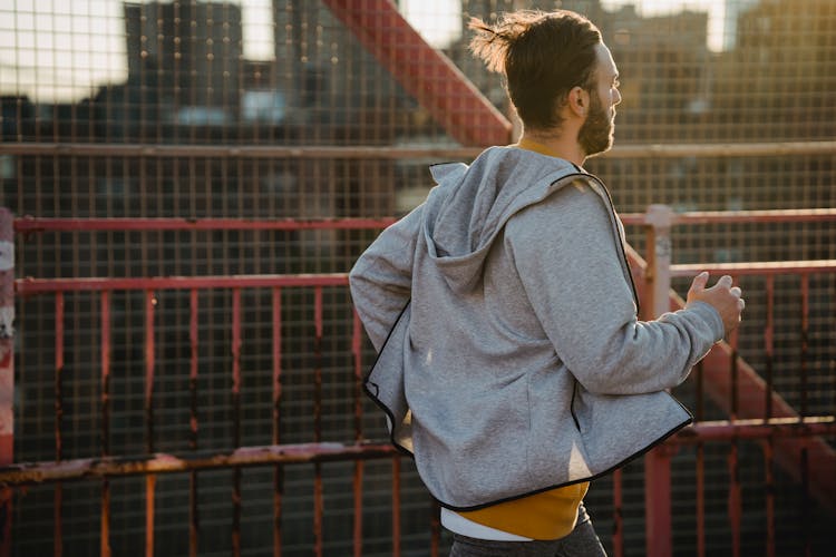 Hipster Runner Jogging On Urban Bridge During Workout