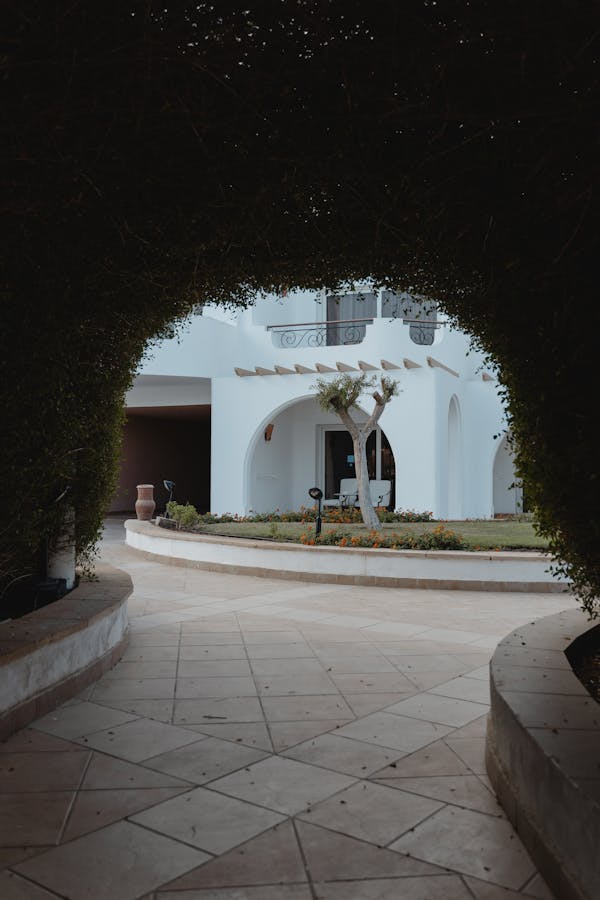 White Concrete Building With Green Trees