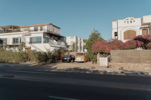 Charming street view of Mediterranean-style buildings under clear blue sky.