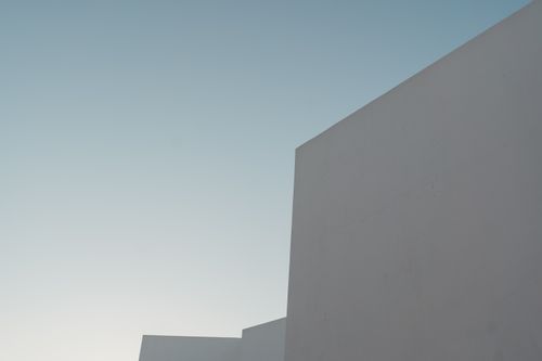 Free A minimalist view of a modern building's facade under a clear blue sky. Stock Photo