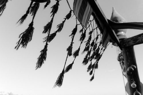 Free Monochrome image of hanging tassel decorations outdoors against the sky. Stock Photo