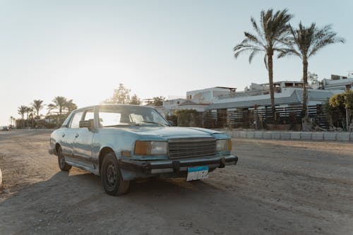 Blue Car Parked on Unpaved Road