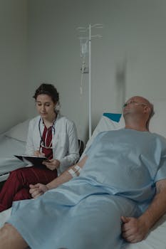 Doctor consulting with a patient in a hospital room, assessing medical condition.