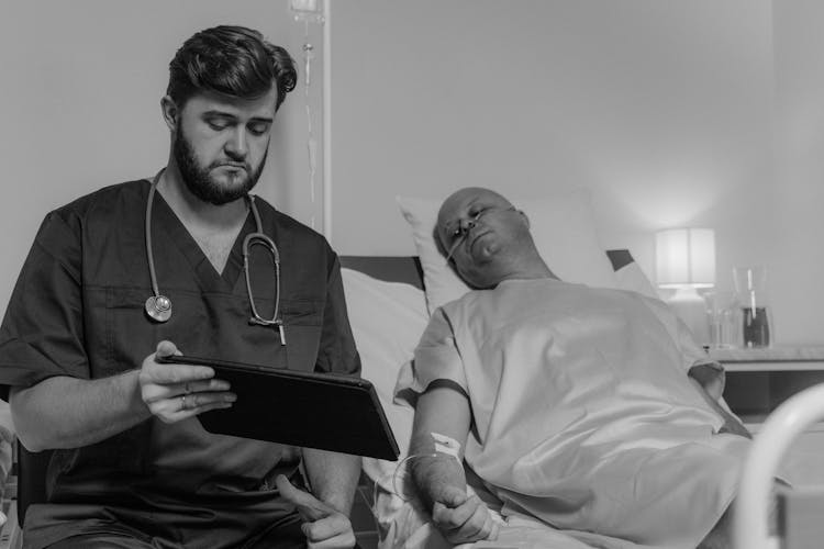 Doctor And A Patient Looking At A Digital Tablet