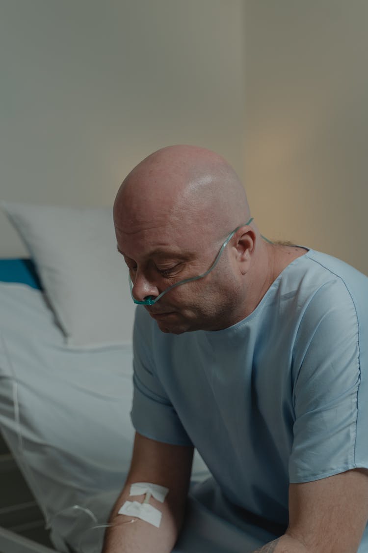 Patient Sitting On Hospital Bed