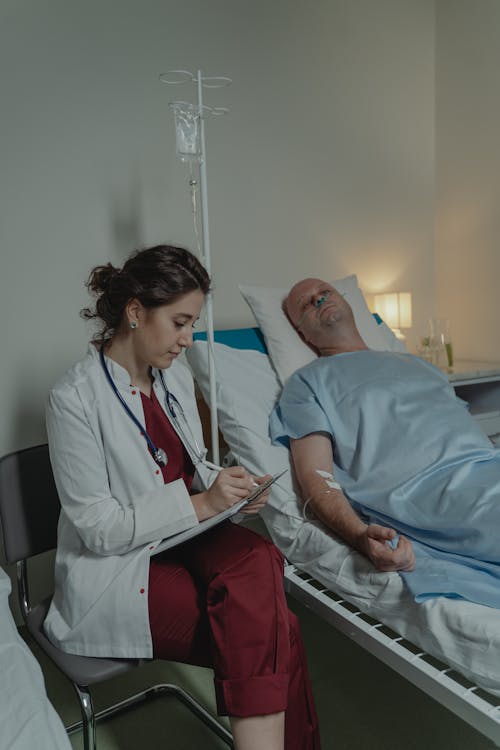 Doctor Sitting beside a Patient