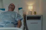 Man in Blue Scrub Suit Lying on Bed