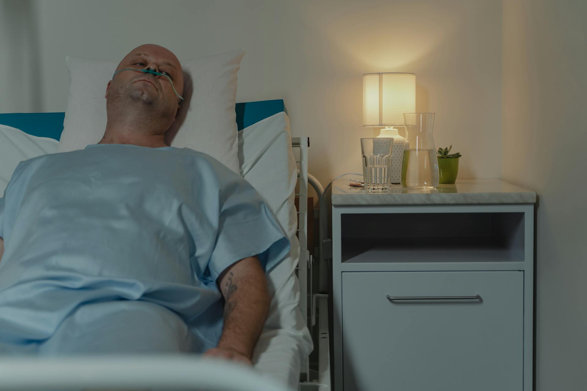 Sick Man Lying on Hospital Bed