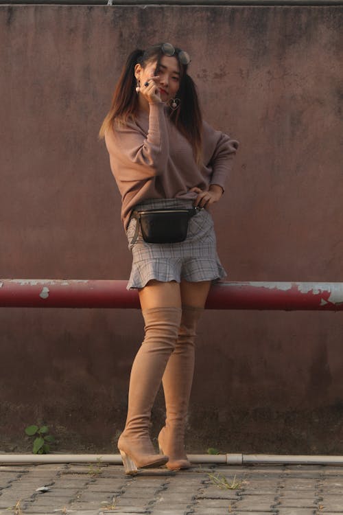 A Woman Wearing Brown Long Sleeves and Skirt 