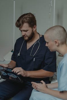 A doctor with a stethoscope discusses MRI results with a patient using a digital tablet.
