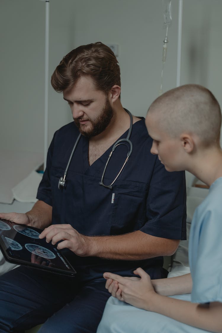 A Nurse And Patient Looking The Digital Tablet