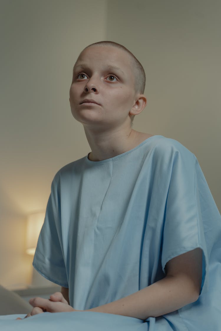 A Hairless Girl Wearing Hospital Gown
