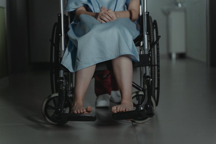 A Person Sitting On The Wheelchair