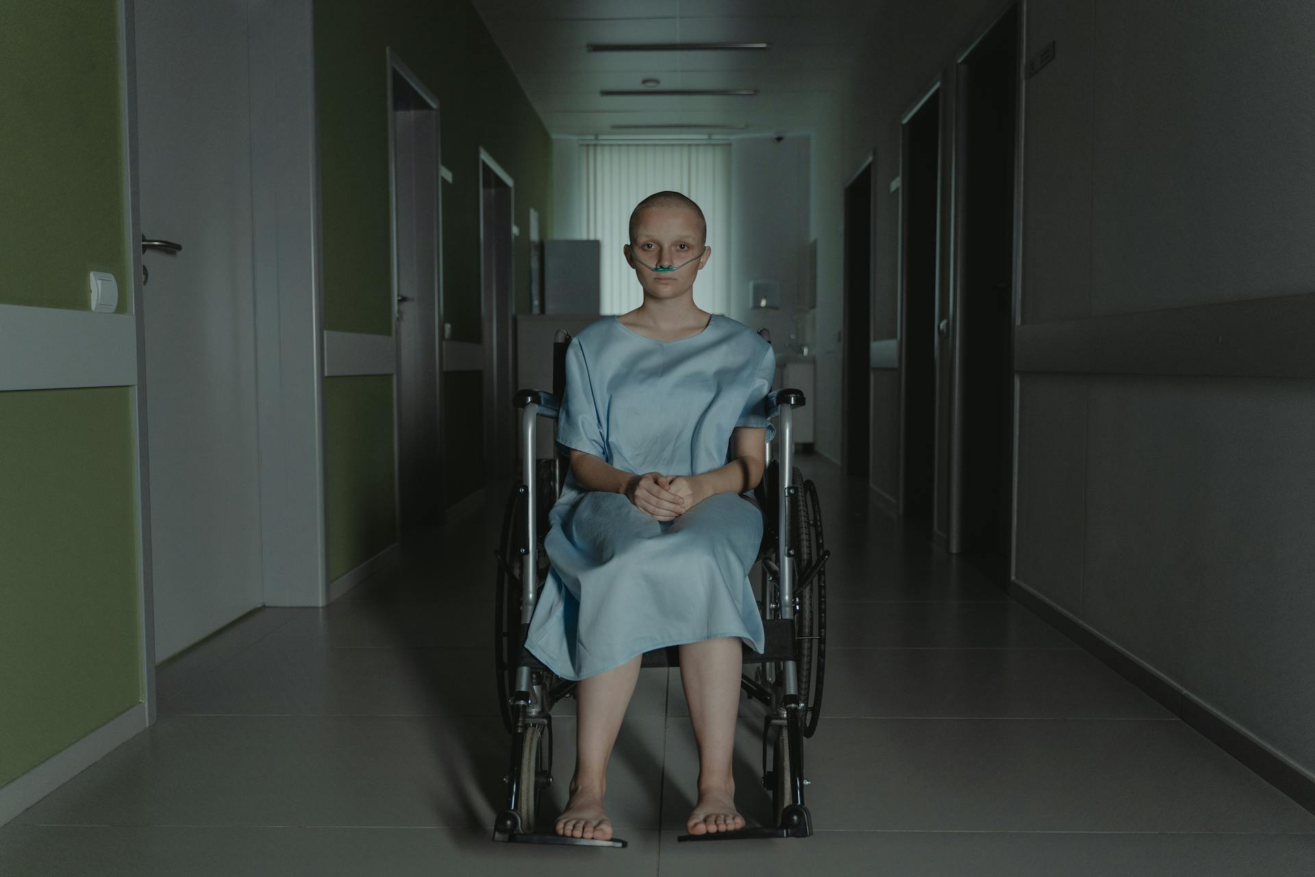 A Hairless Girl Sitting on the Wheelchair