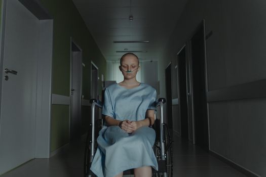 Woman in Gray Crew Neck T-shirt Sitting on Black Wheelchair