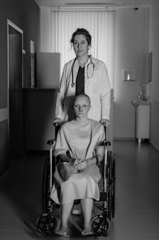 A doctor stands behind a patient in a wheelchair in a hospital setting, illustrating healthcare and support.