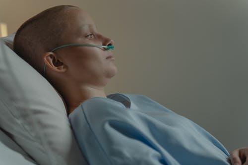 Free Bald Woman Lying on Hospital Bed Stock Photo