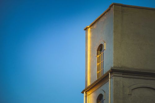 Free Low angle of aged house made in oriental style with shiny golden walls under blue sky Stock Photo