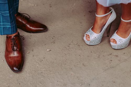 Free Close-up of elegant men's and women's shoes at a formal event, showcasing style and sophistication. Stock Photo