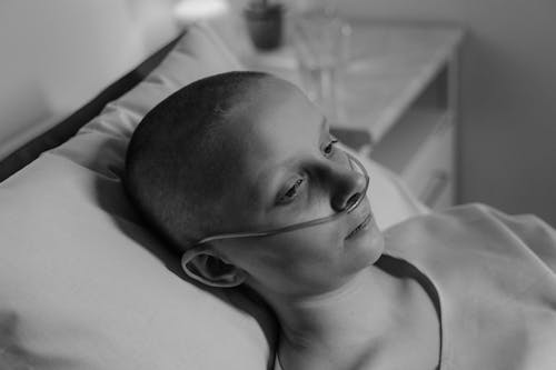 Grayscale Photo of Woman Wearing a Nasal Cannula