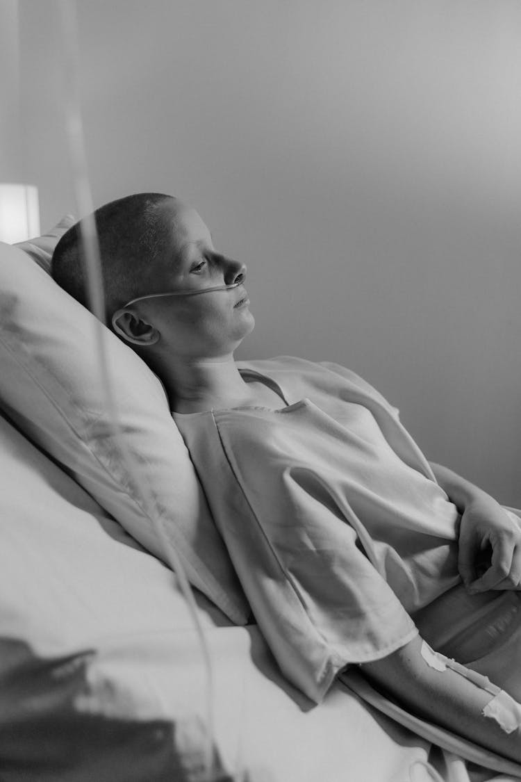 Black And White Photo Of A Cancer Patient Lying On The Bed