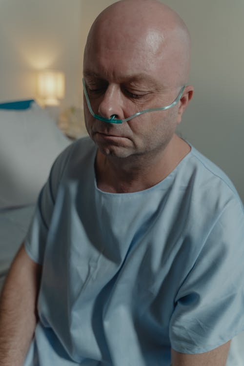 Close-up Photo of a Sick Man Wearing Nasal Cannula