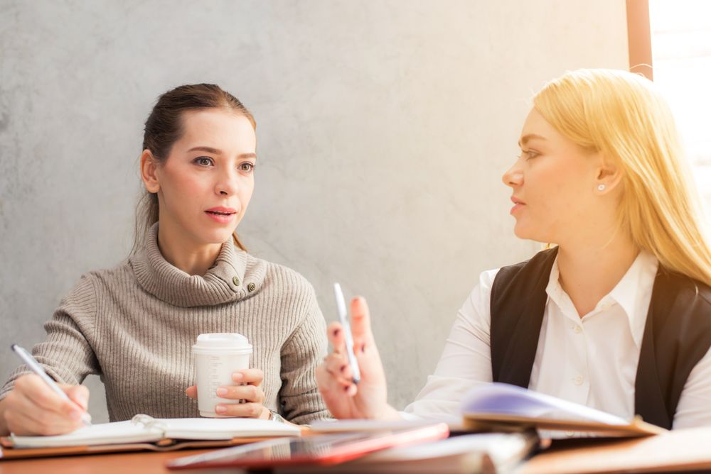 Professional woman in conversation, representing the summit's founder community