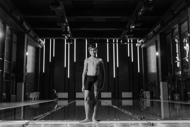 Boy Standing At The Poolside