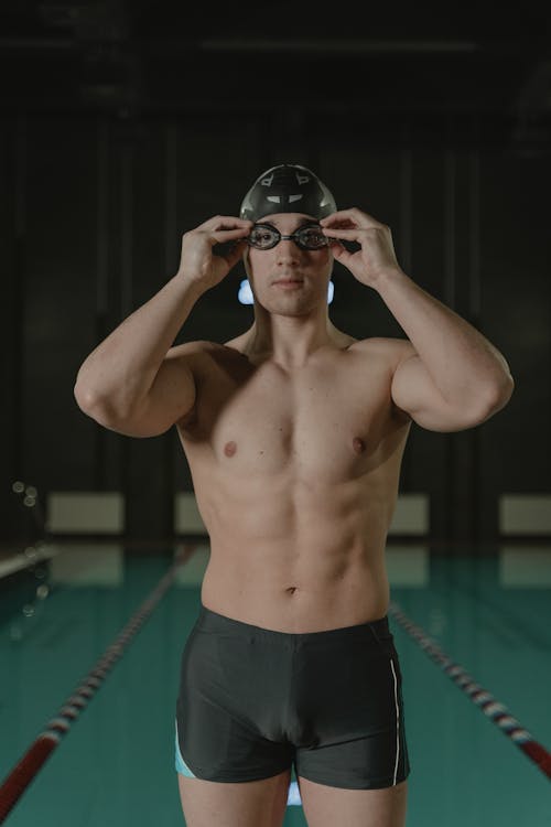 Topless Man Wearing Swimming Goggles and Swimming Cap