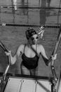 Monochrome Photo of Woman Getting Out of the Swimming Pool