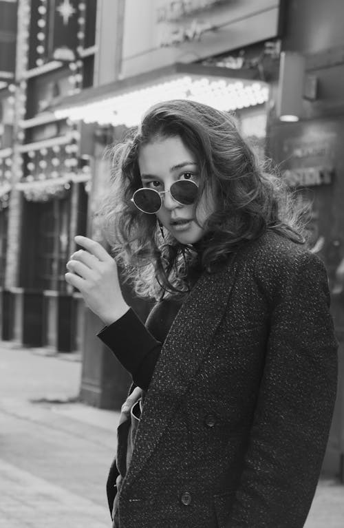 Woman with wavy hair in stylish sunglasses
