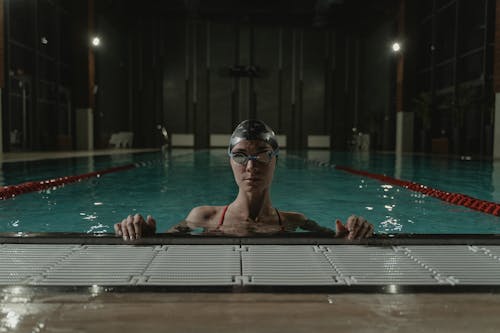 Person Wearing Swimming Cap and Goggles