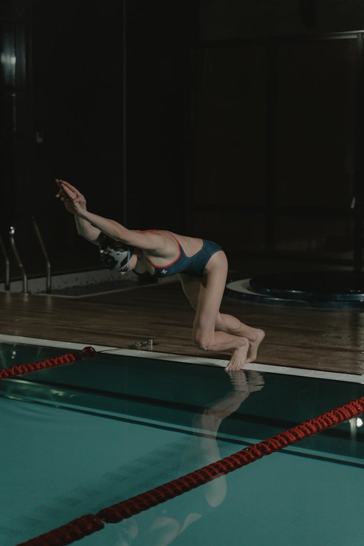 A Woman Diving On The Swimming Pool