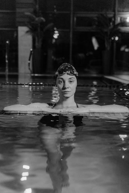 Grayscale Photo of Woman in Swimming Pool