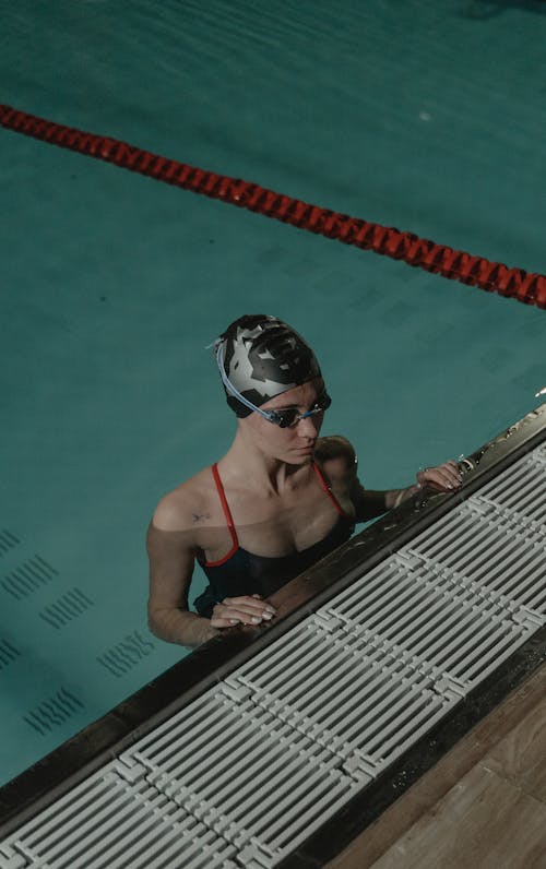 High-Angle Shot of Woman Wearing Swimming Cap and Goggles in the Swimming Pool