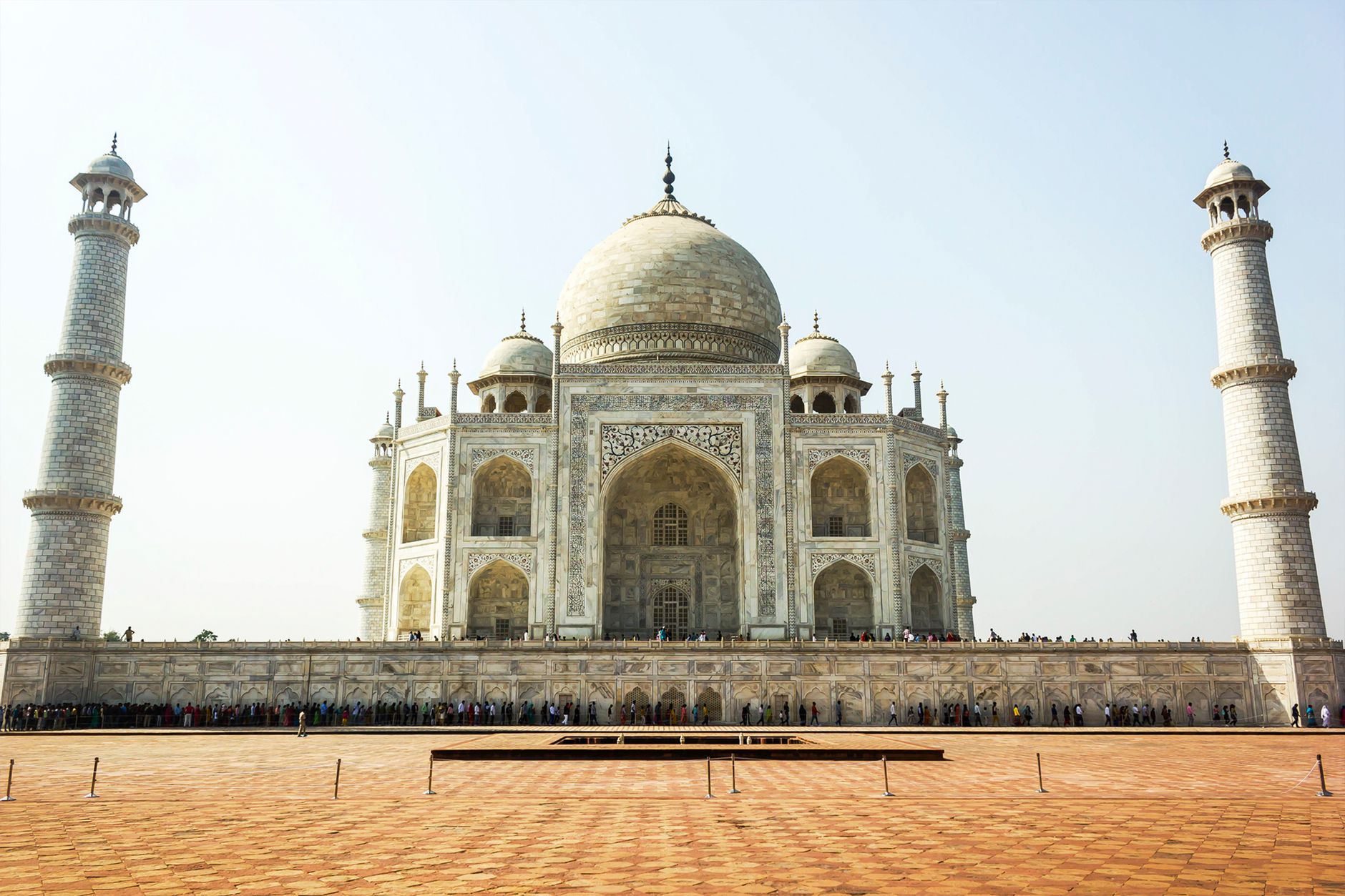 Front view of the Taj Mahal in Agra, India, showcasing its stunning marble architecture and minarets.