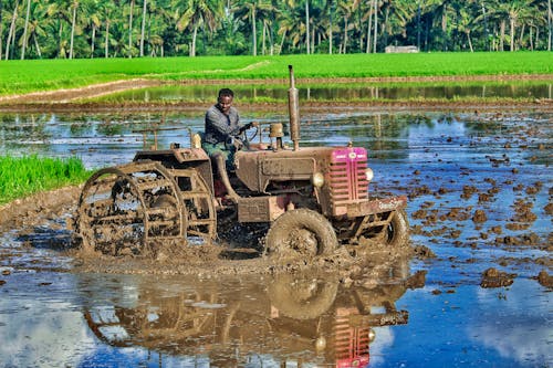 Free A Man Riding a Tractor Stock Photo