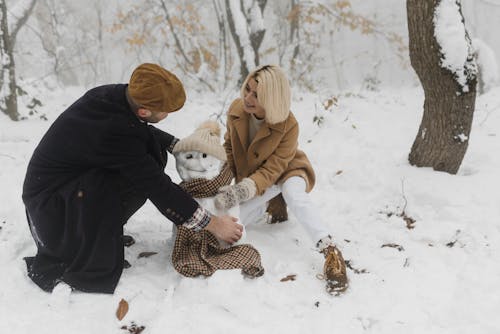 Couple Making a Snowman Together