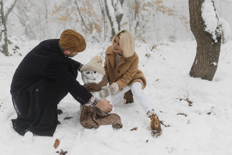 Couple Making A Snowman Together