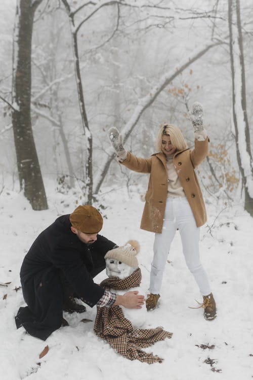 Couple Making a Snowman Together