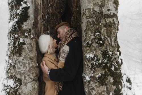 Couple Wearing Winter Clothes Looking at Each Other