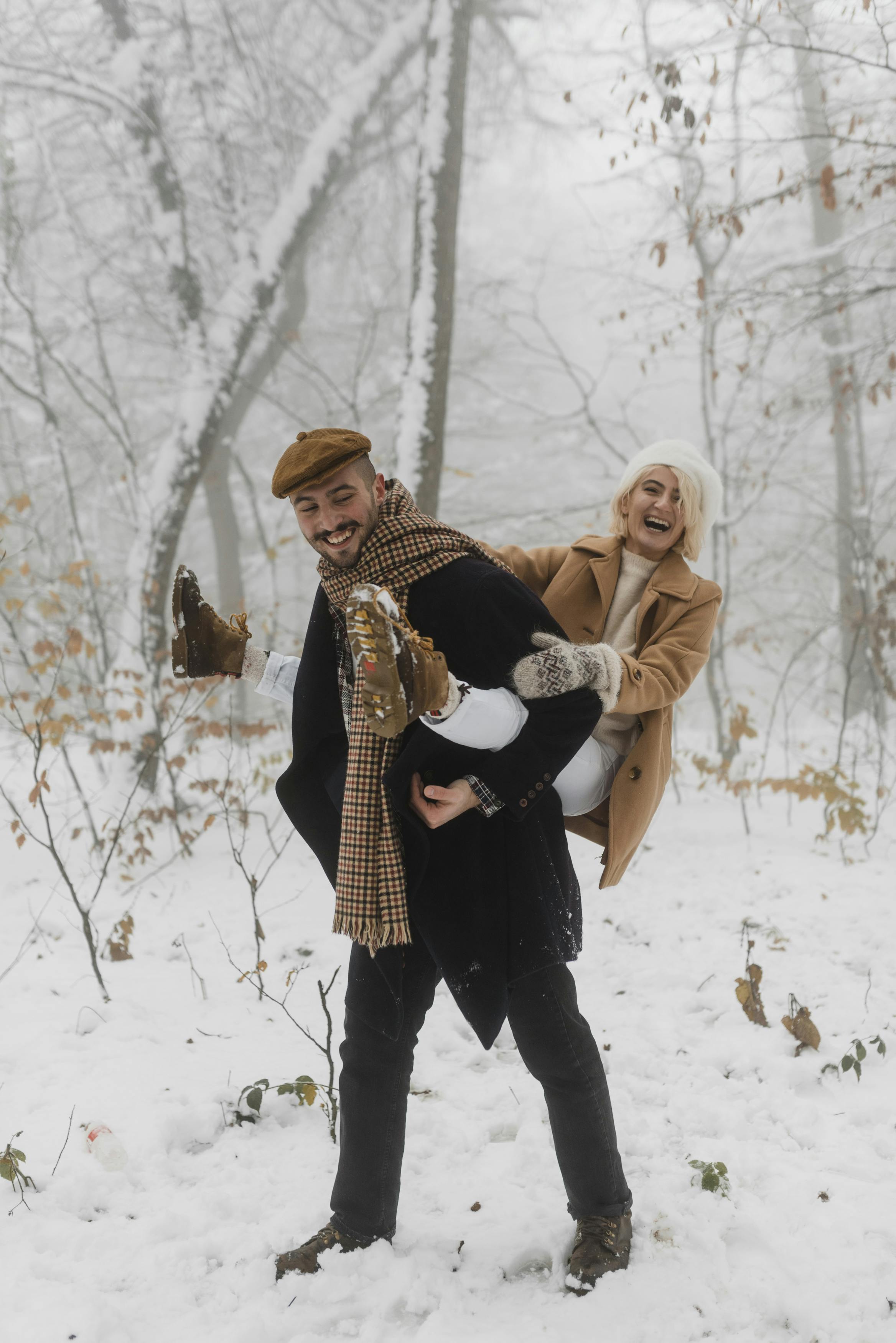 couple in winter clothes having fun outdoors