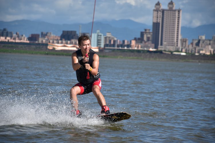 A Man Wakeboarding On The Lake