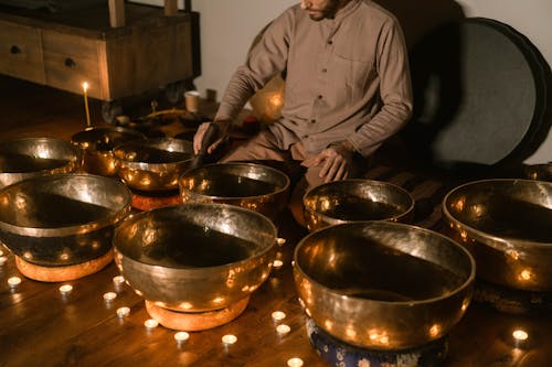 A Man Playing Singing Bowls