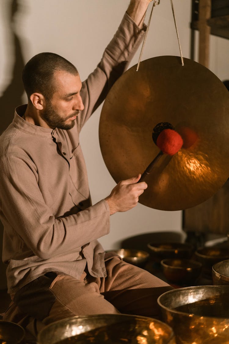 A Man Holding A Cymbal