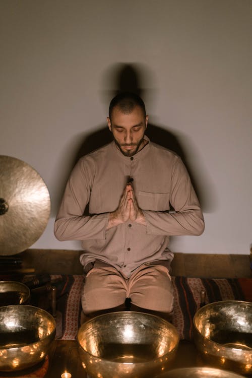 Free A Man in Brown Long Sleeve Shirt Meditating Stock Photo