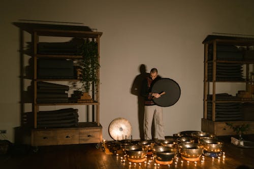 A Man Standing Beside the Singing Bowls