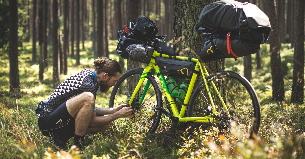 Tourenfahrrad mit Gepäcktaschen, Trinkflasche, Regenjacke und Reparaturwerkzeug für eine Tagestour