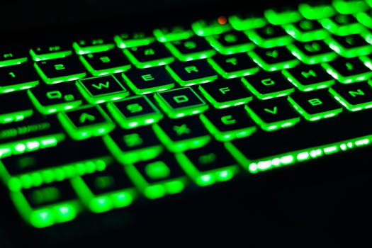 Vibrant green backlit keyboard with visible QWERTY layout. Perfect for tech-related visuals.
